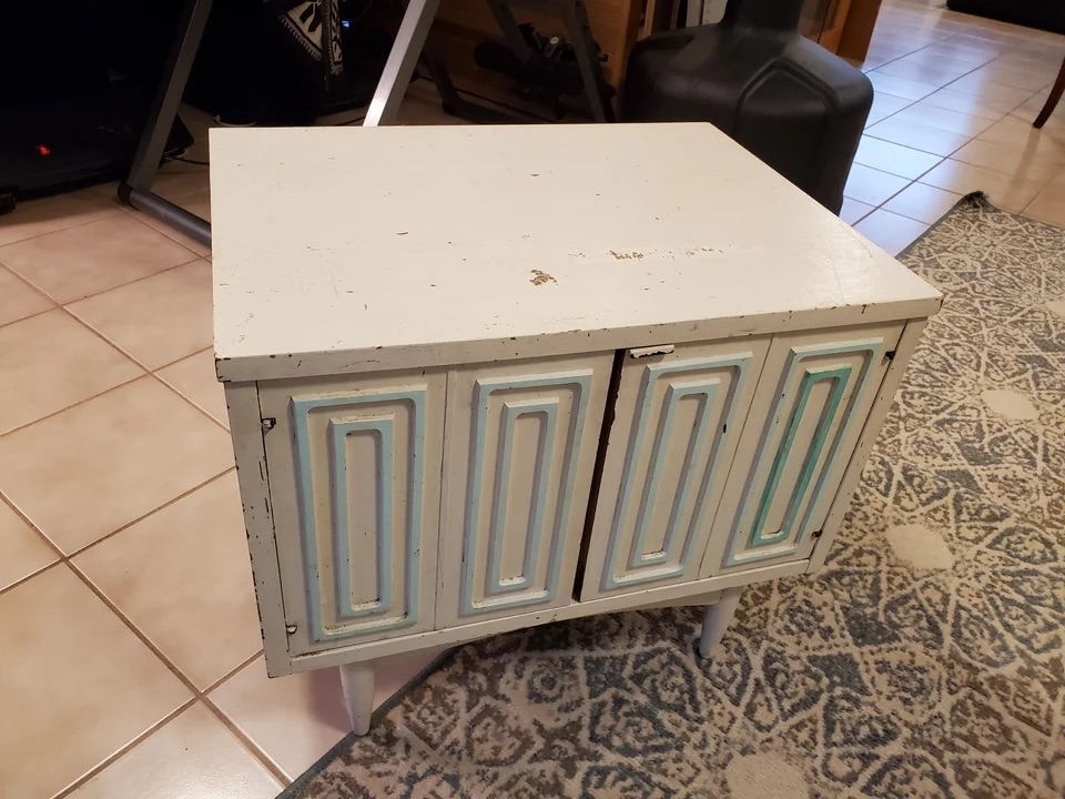 A before image of a mid-century modern night stand covered in white and blue paint