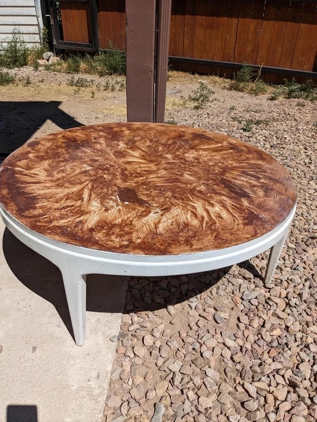 A before image of a coffee table with stain smeared all over it