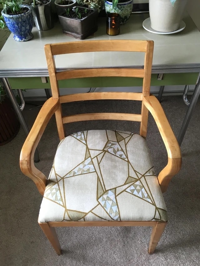 The chair after with a light wood stain and patterned fabric cushion