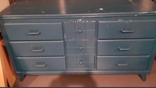 A before image of a dresser covered in dark blue paint