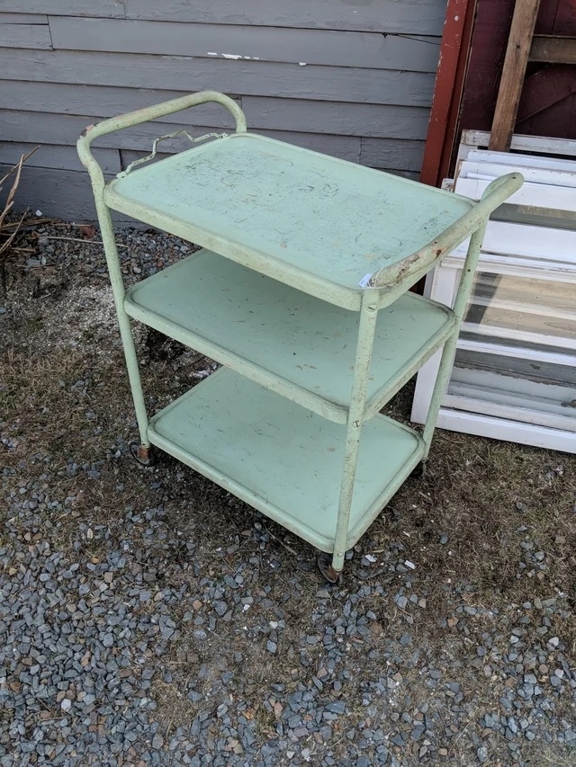 A before image of a small three-tray cart painted teal