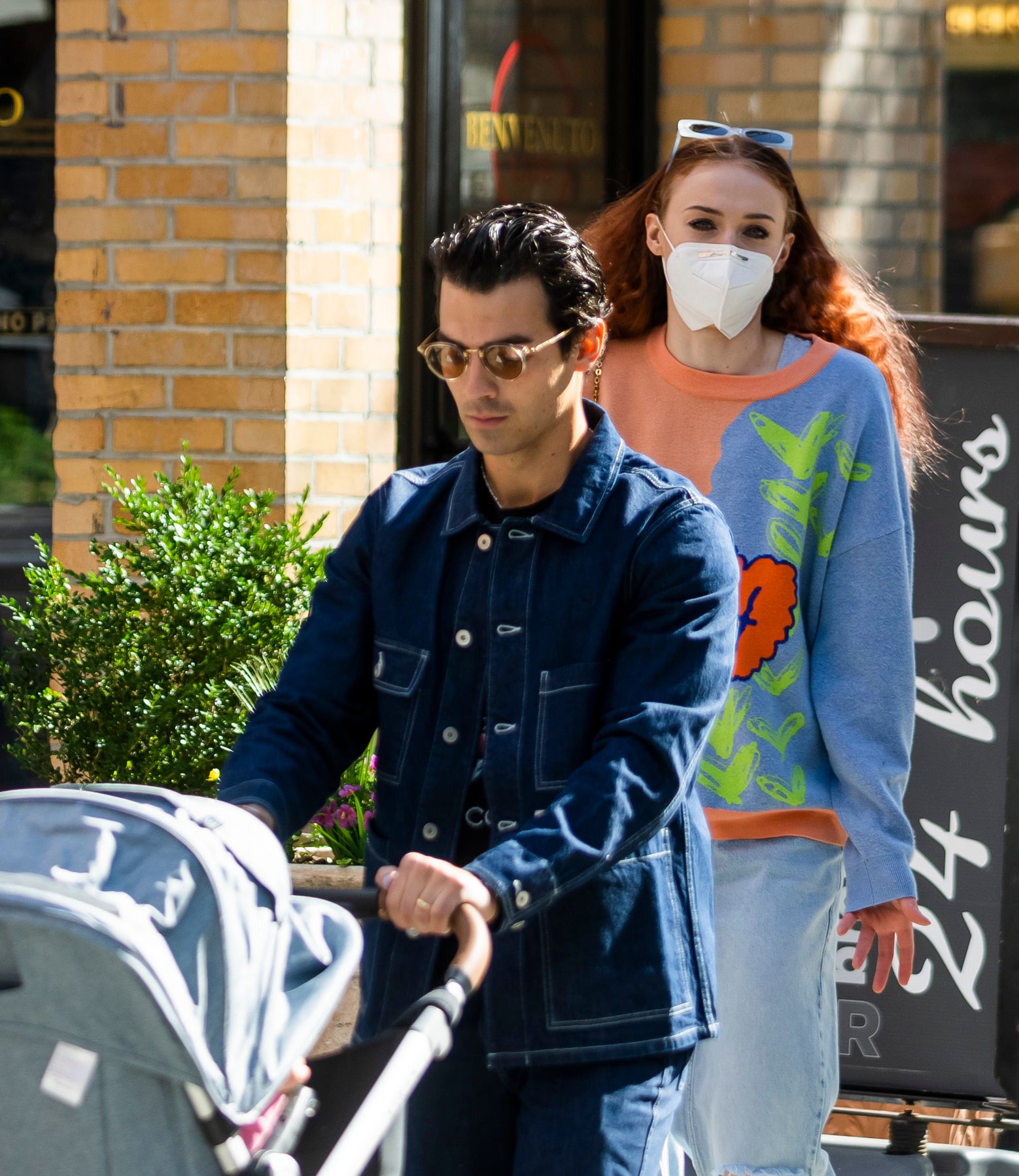 Joe Jonas pushing a stroller with Sophie walking behind him