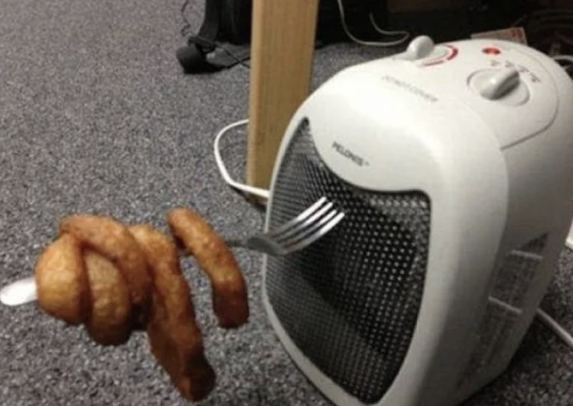 fork in a heater with onion rings attached