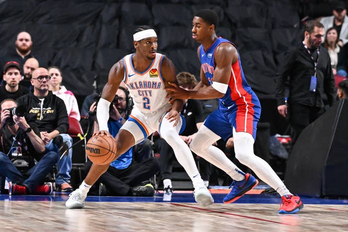 Shai Gilgeous-Alexander #2 of the Oklahoma City Thunder dribbles the ball against Jaden Ivey #23 of the Detroit Pistons during the first half of a preseason NBA game at Bell Centre on October 12, 2023 in Montreal, Quebec, Canada.
