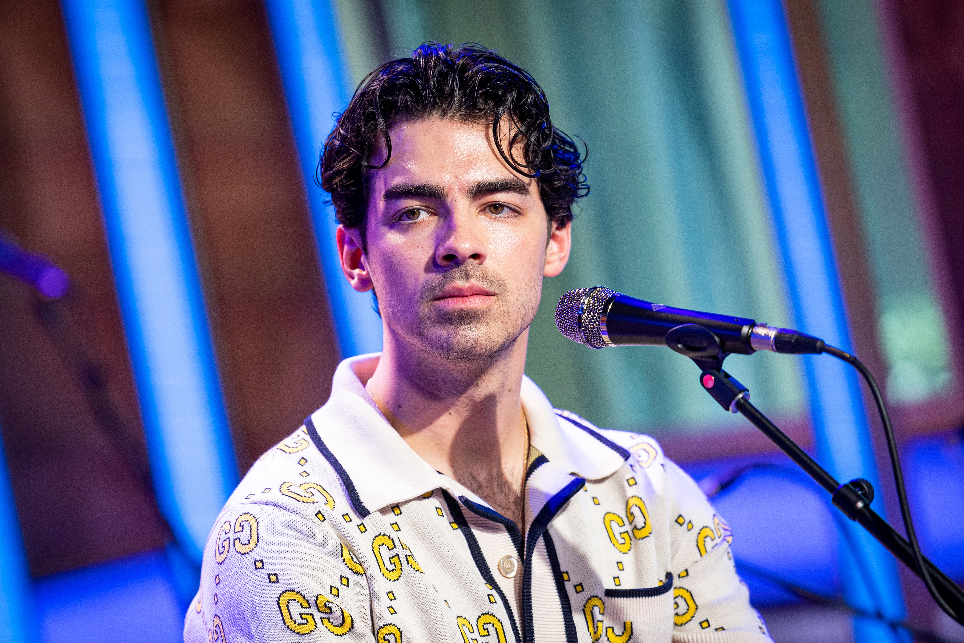 Close-up of Joe sitting at a microphone