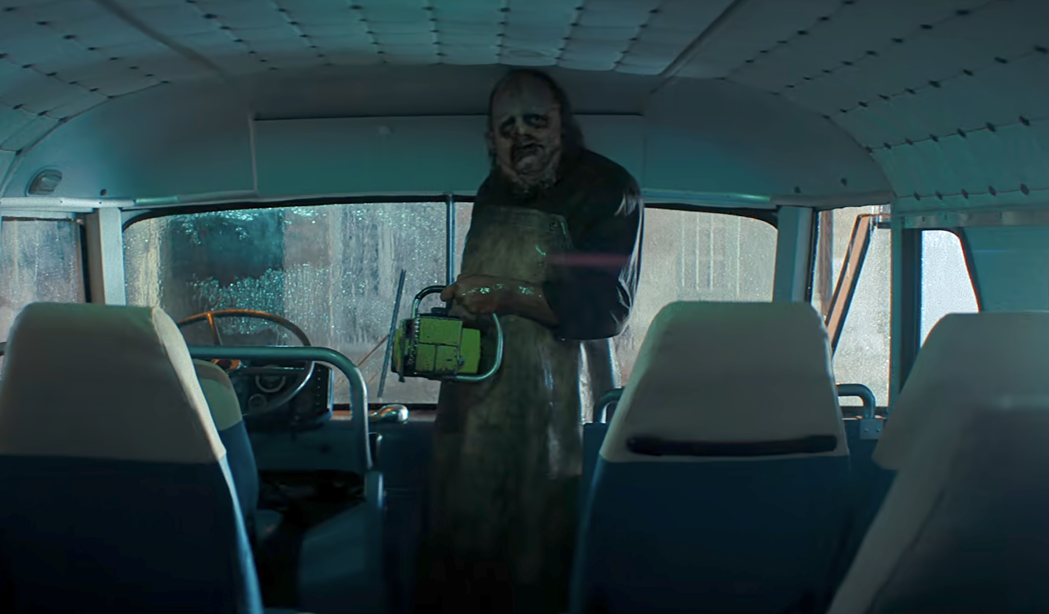 Leatherface standing on a bus with his chainsaw