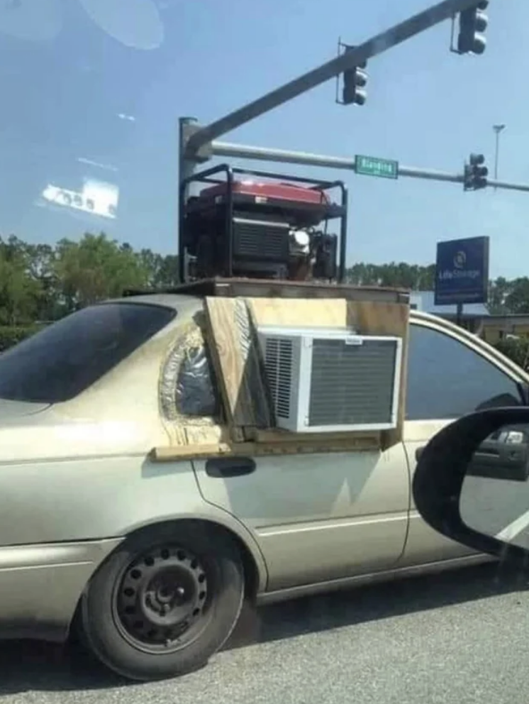 window unit AC attached to a car