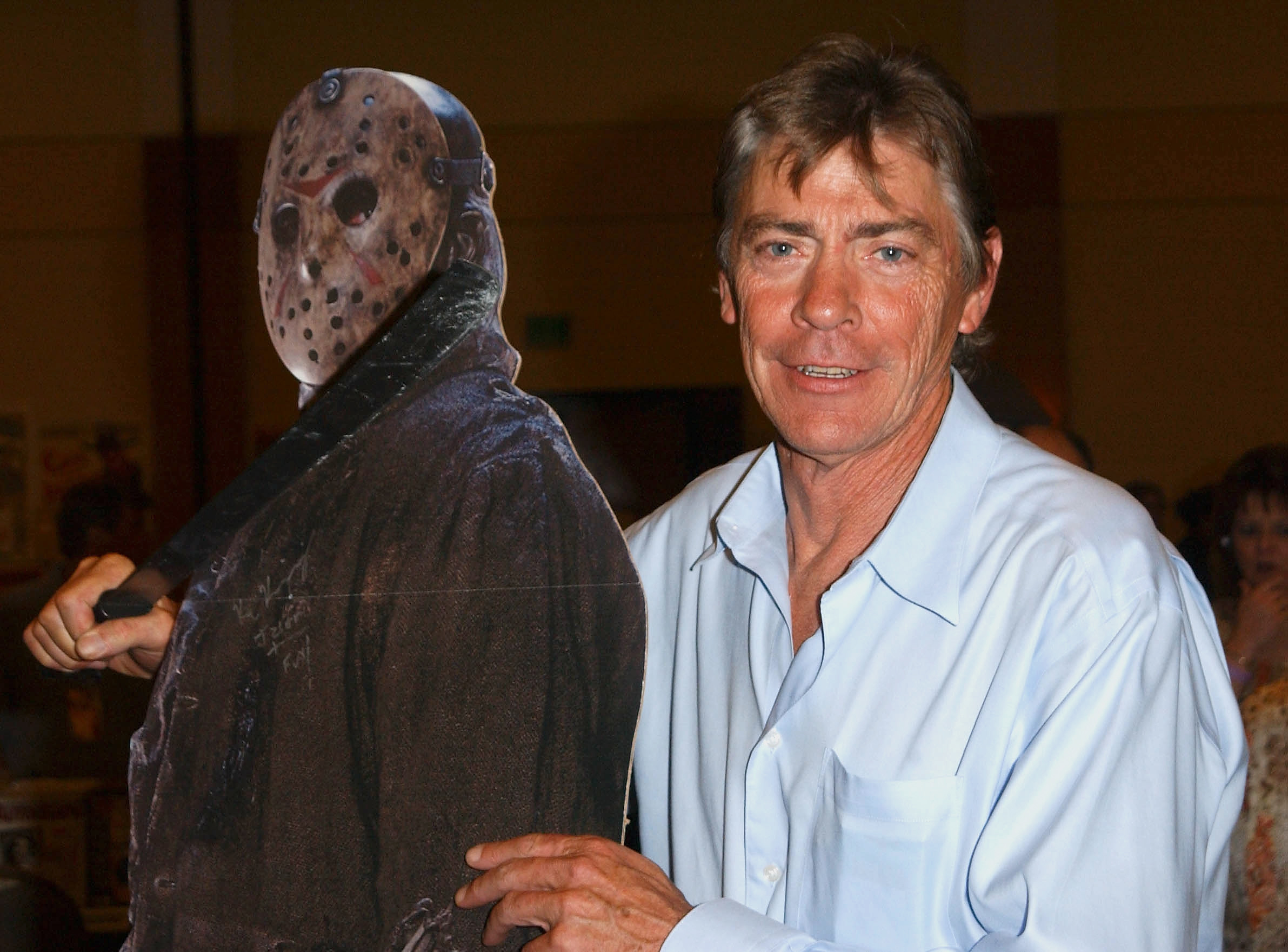 Richard Brooker next to a cardboard cutout of Jason Voorhees
