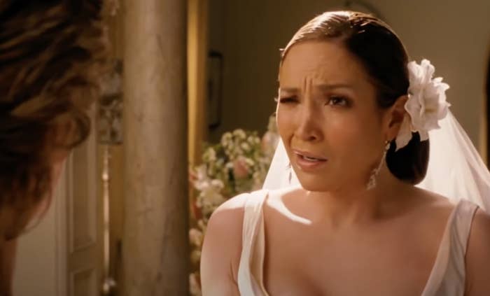 Jennifer Lopez as a bride looking dismayed