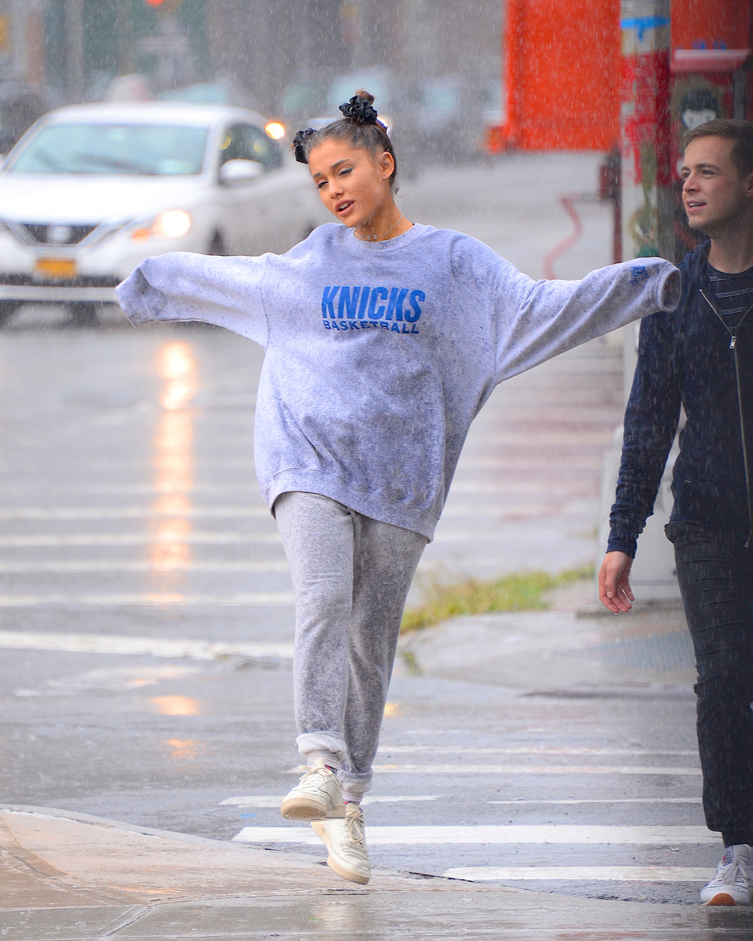 ariana skipping in the rain in a sweats
