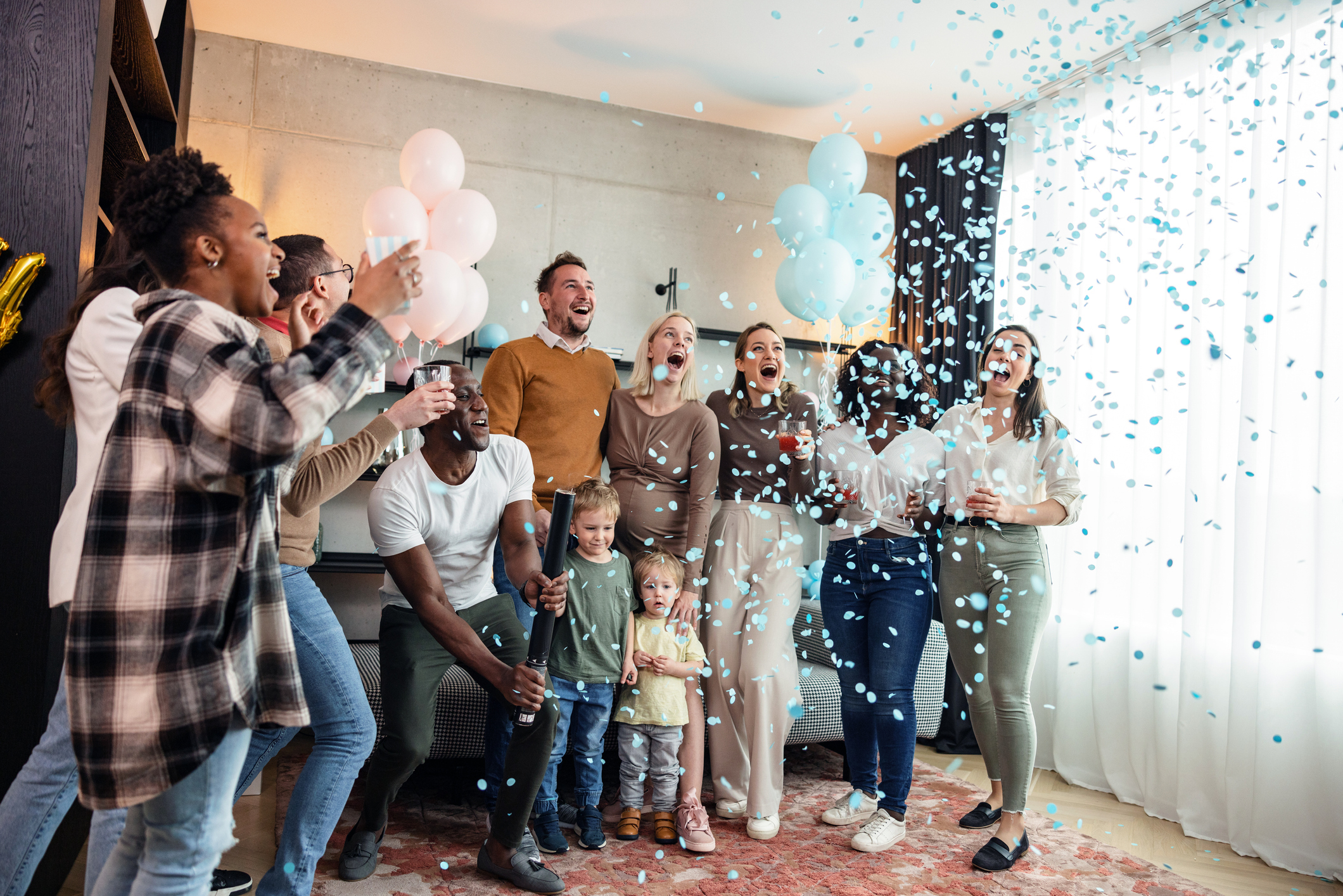 people popping a balloon at a gender reveal party