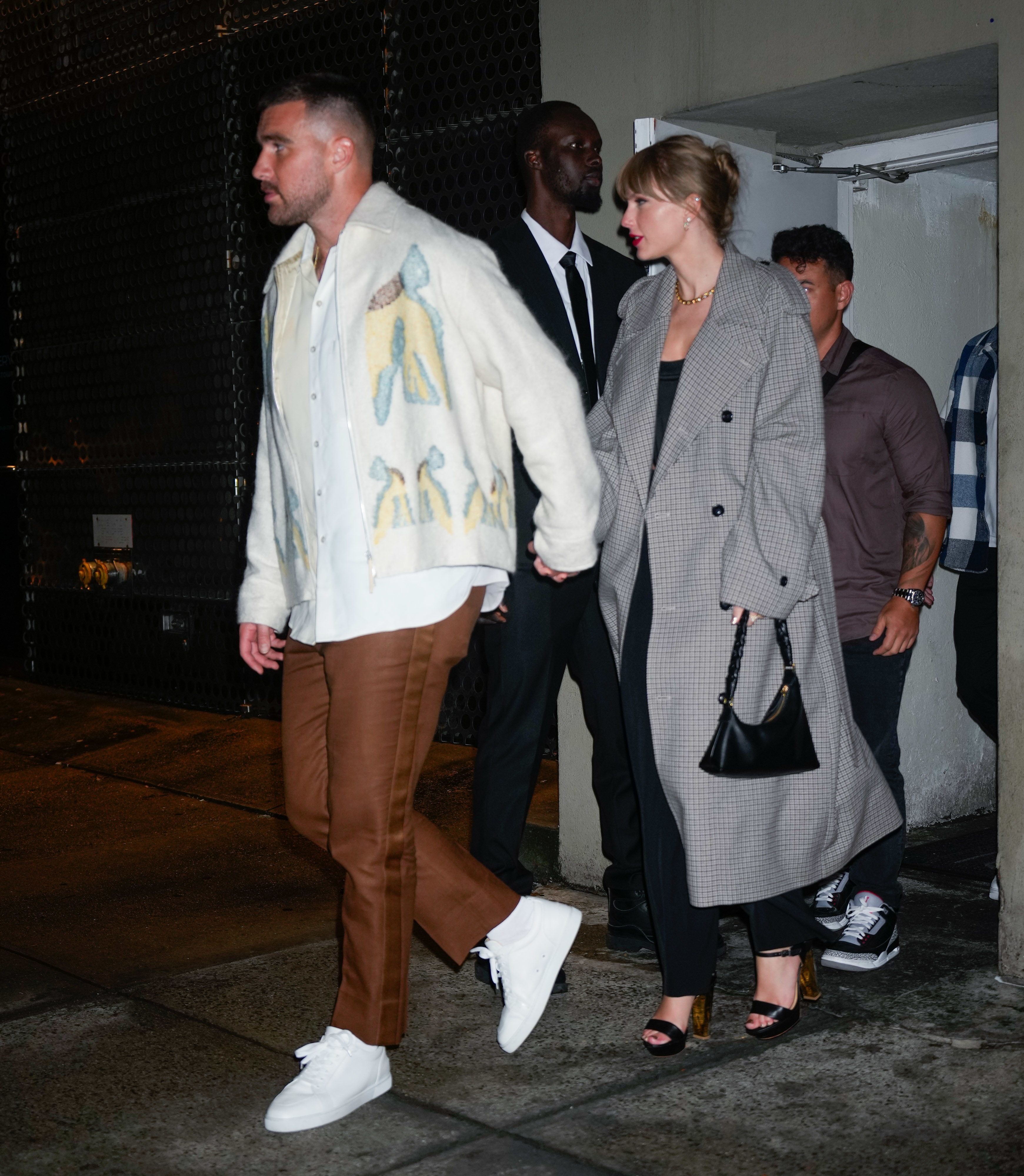 Close-up of Taylor and Travis walking hand in hand