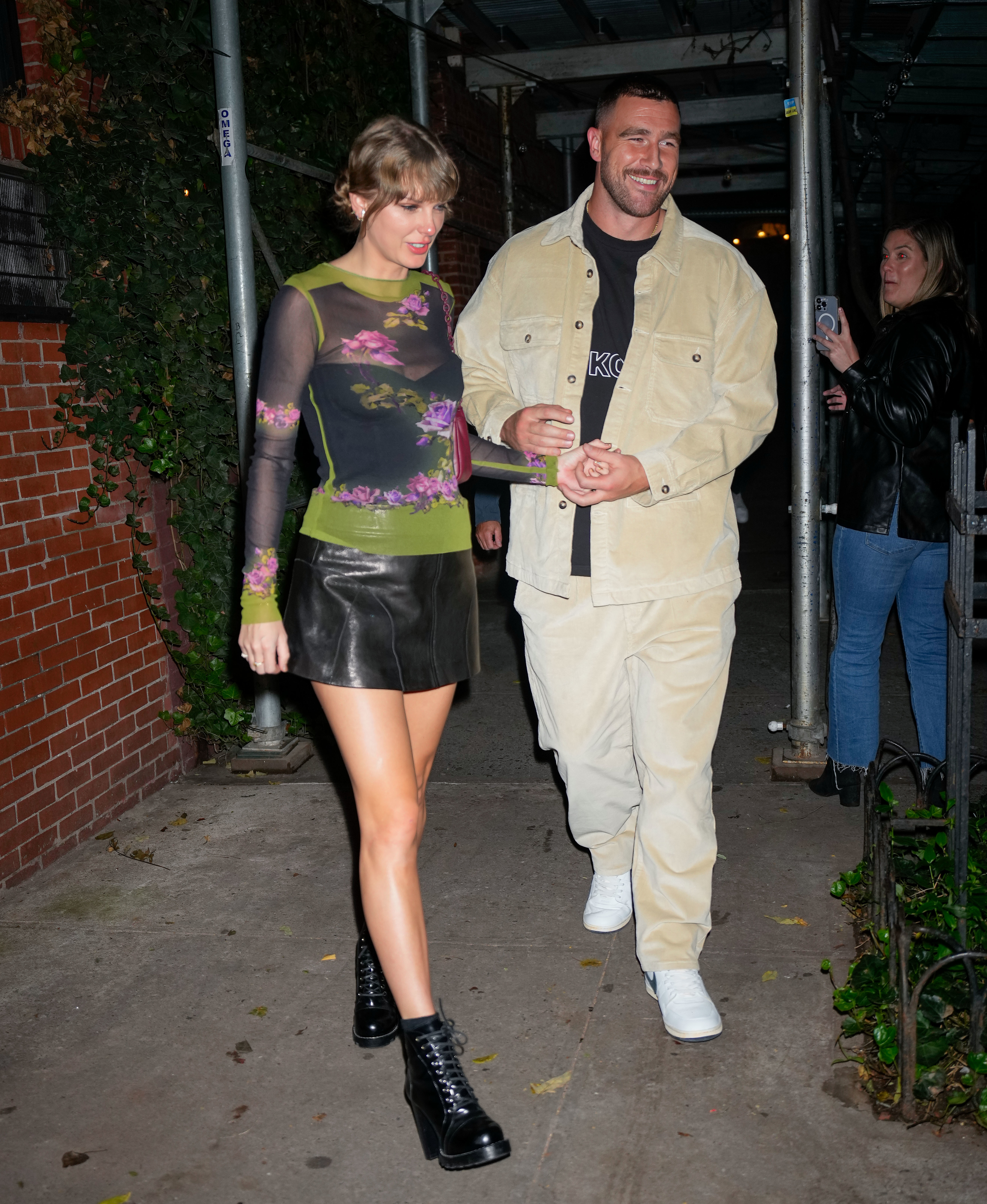 Close-up of Taylor and Travis walking and holding hands