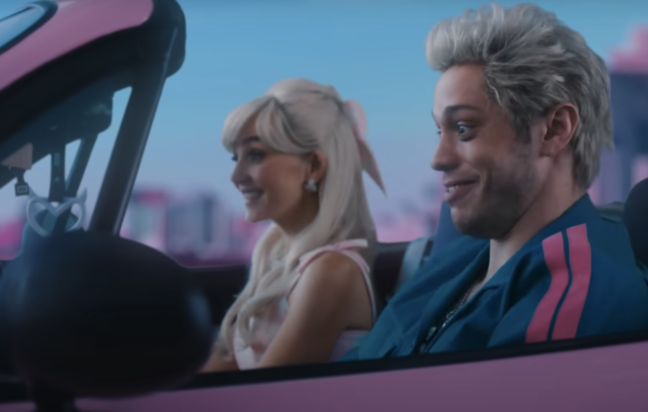 Close-up of Pete sitting in a car with a woman