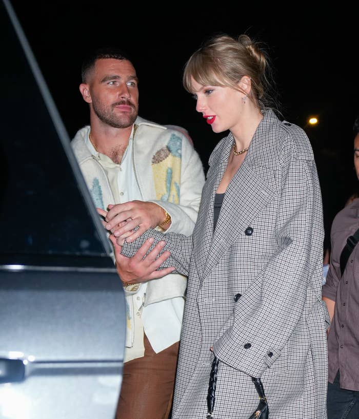 Close-up of Travis and Taylor holding hands at a car