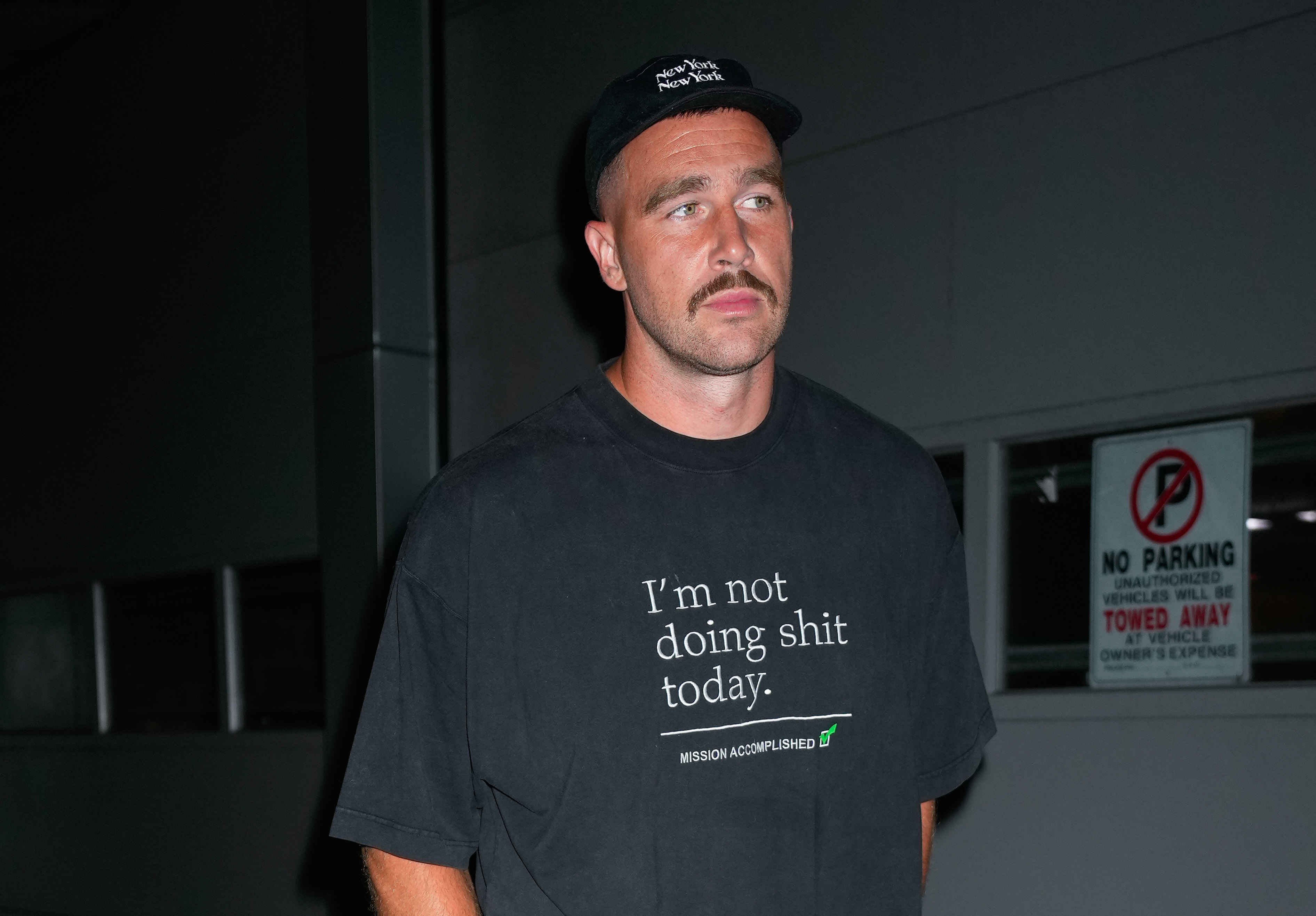 Close-up of Travis wearing a &quot;I&#x27;m not doing shit today&quot; T-shirt