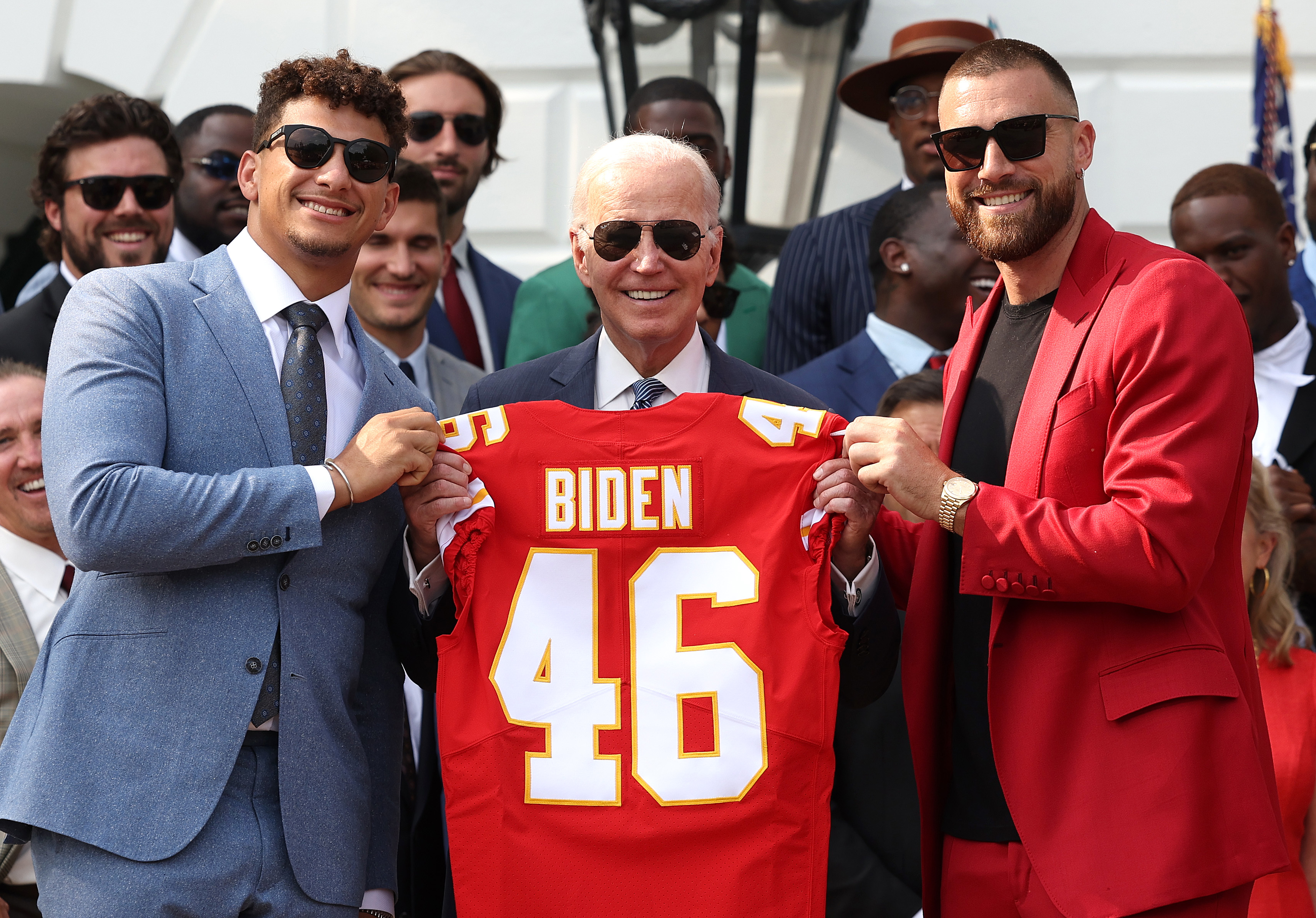 The team with Biden, who&#x27;s holding up a &quot;Biden 46&quot; football jersey