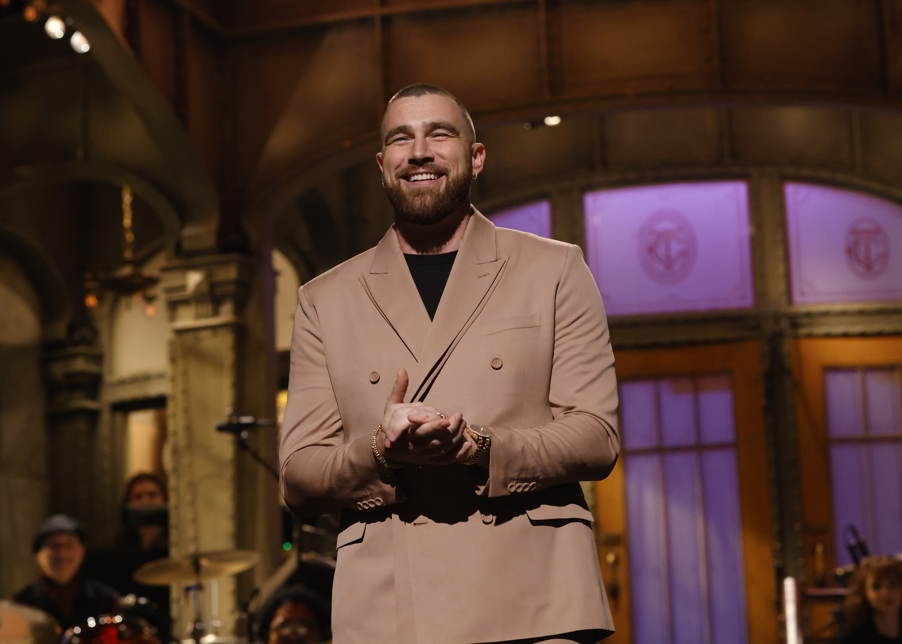 Close-up of Travis smiling during his SNL monologue