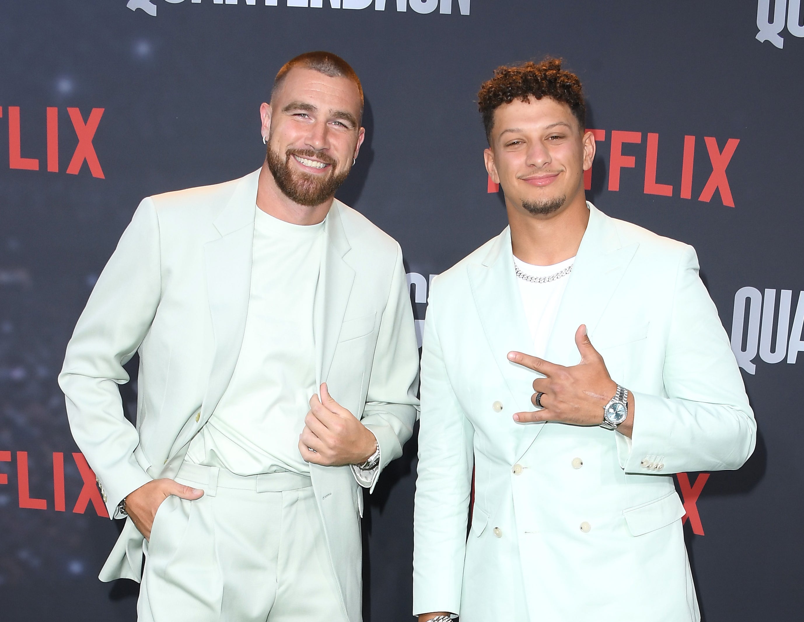 Travis and Patrick smiling at a media event