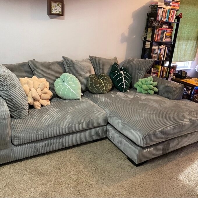 reviewer image of the gray couch with colorful pillows on it