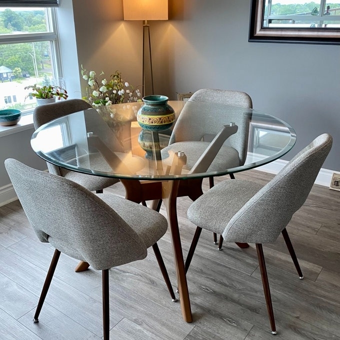 The set of grey upholstered dining chairs around a reviewer&#x27;s table