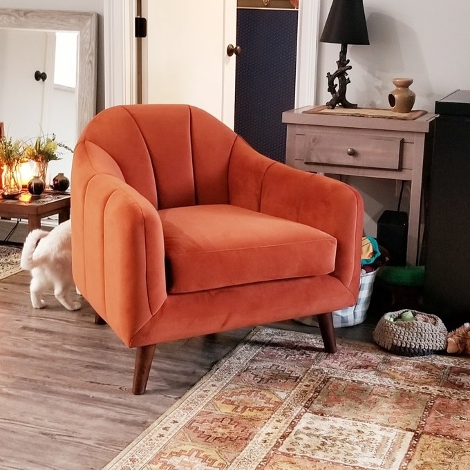 reviewer image of the orange arm chair in their home