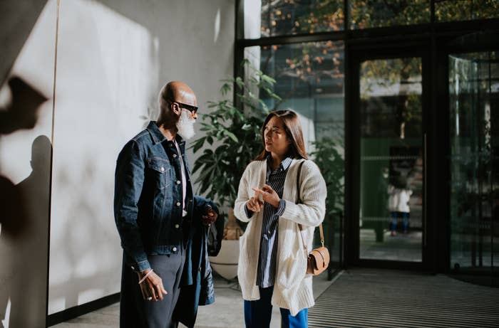 Two adults are conversing with one another