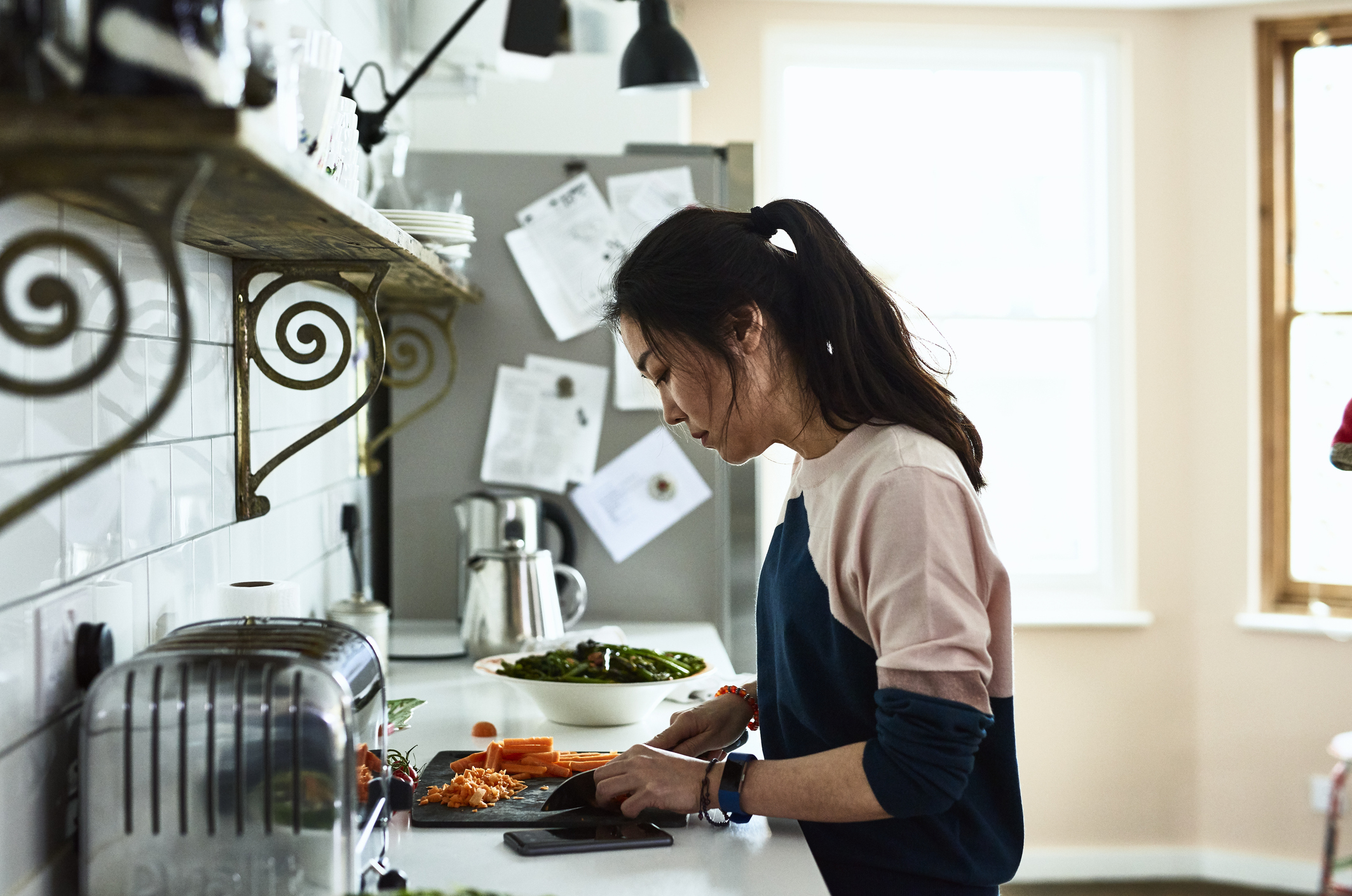 A woman is slicing vegetables