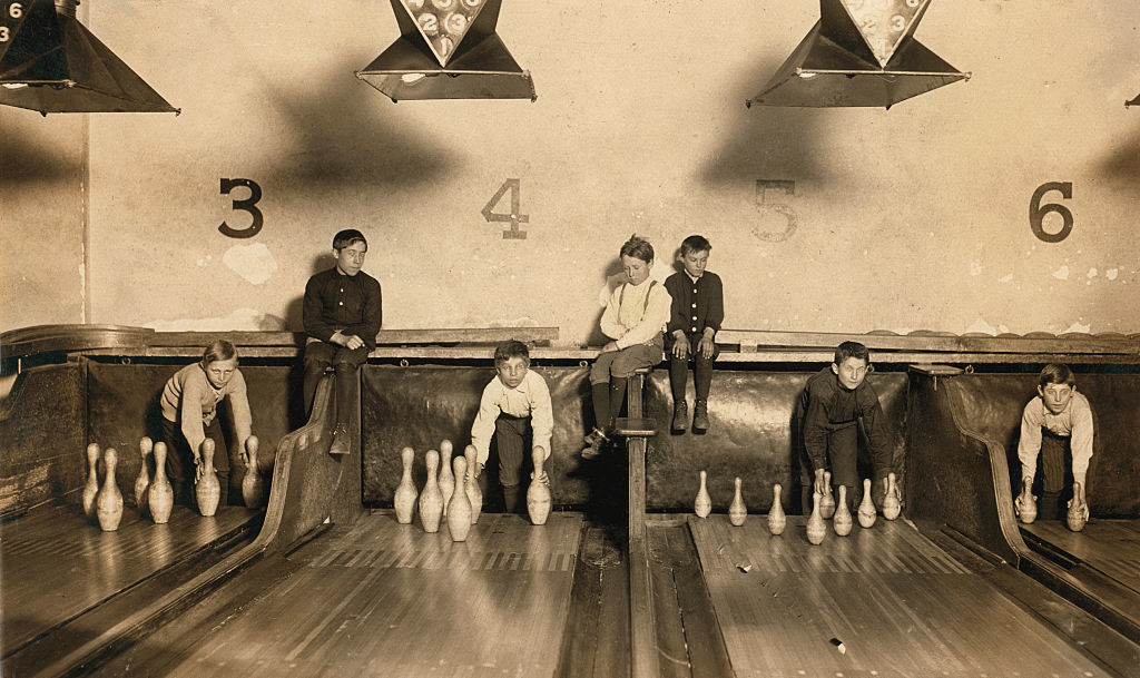 Children setting up bowling pins