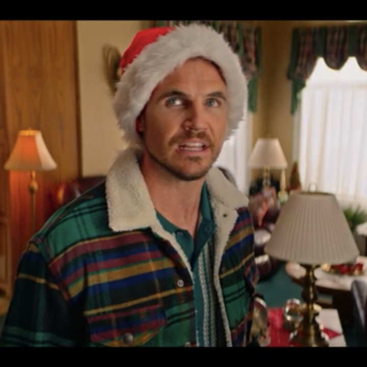 amell in christmas hat looking upset