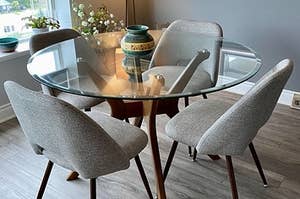 The set of grey upholstered dining chairs around a reviewer's table
