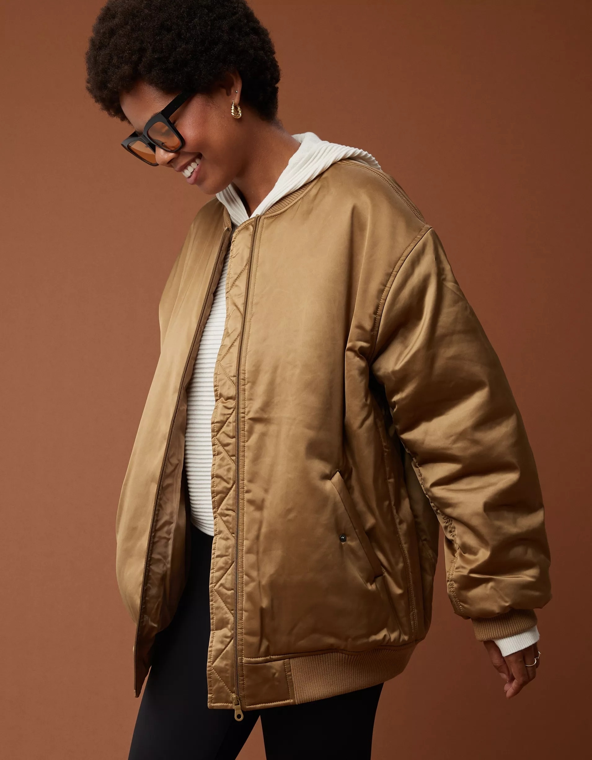 a model wearing the brown shiny bomber jacket