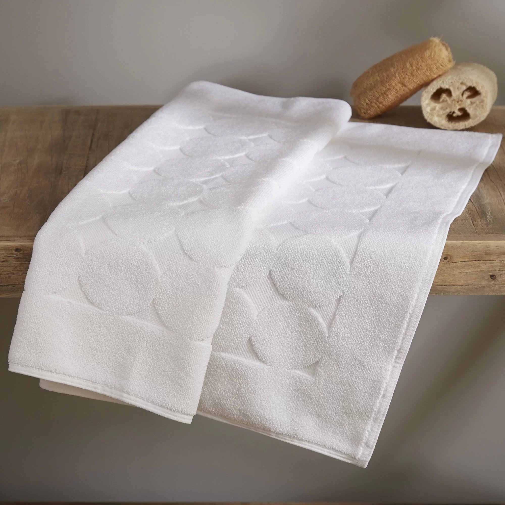 The white bath mat with an embossed circle design