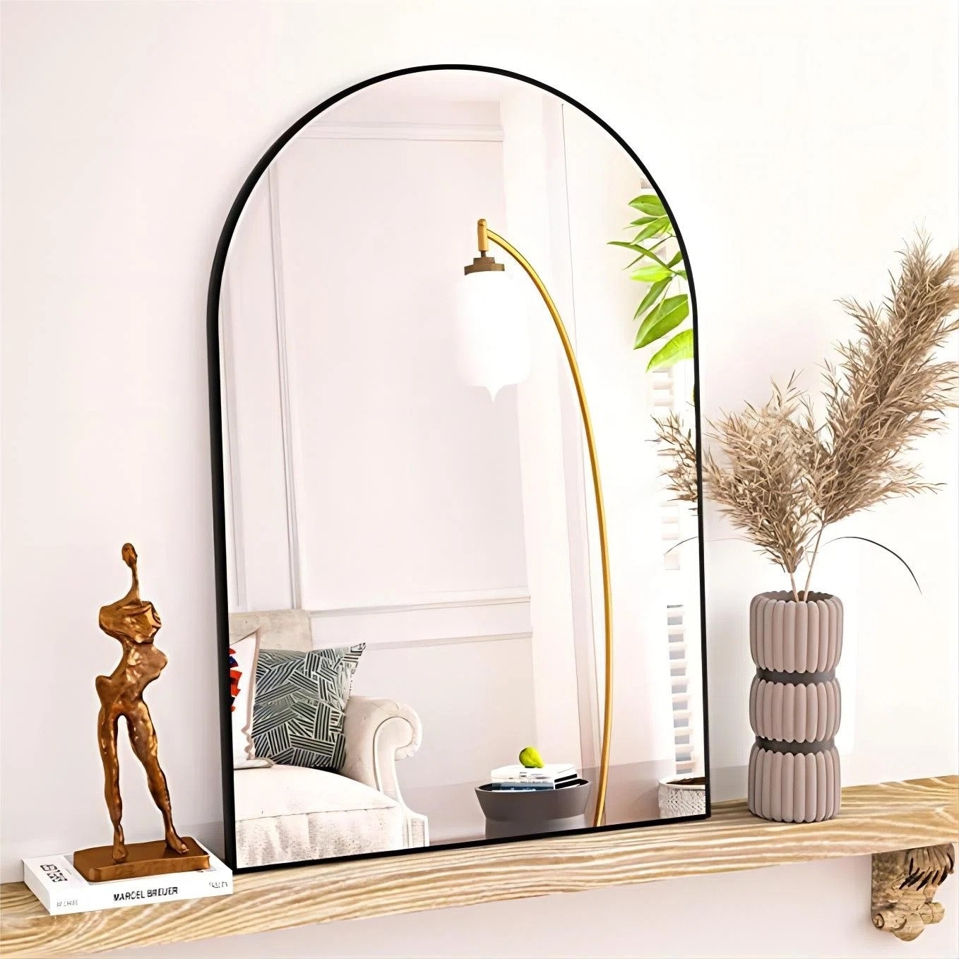 The mirror with a black finish resting on a ledge