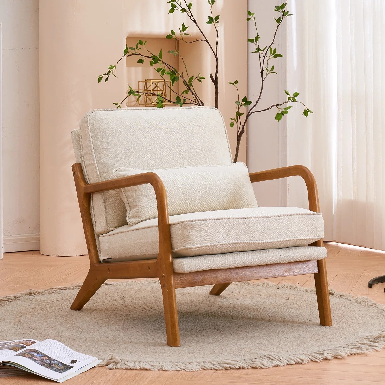 The chair with cream upholstery and natural wooden arms and legs