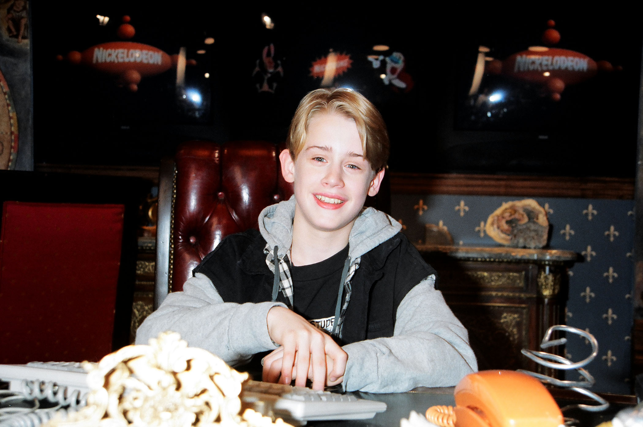 teen macaulay sitting at a table
