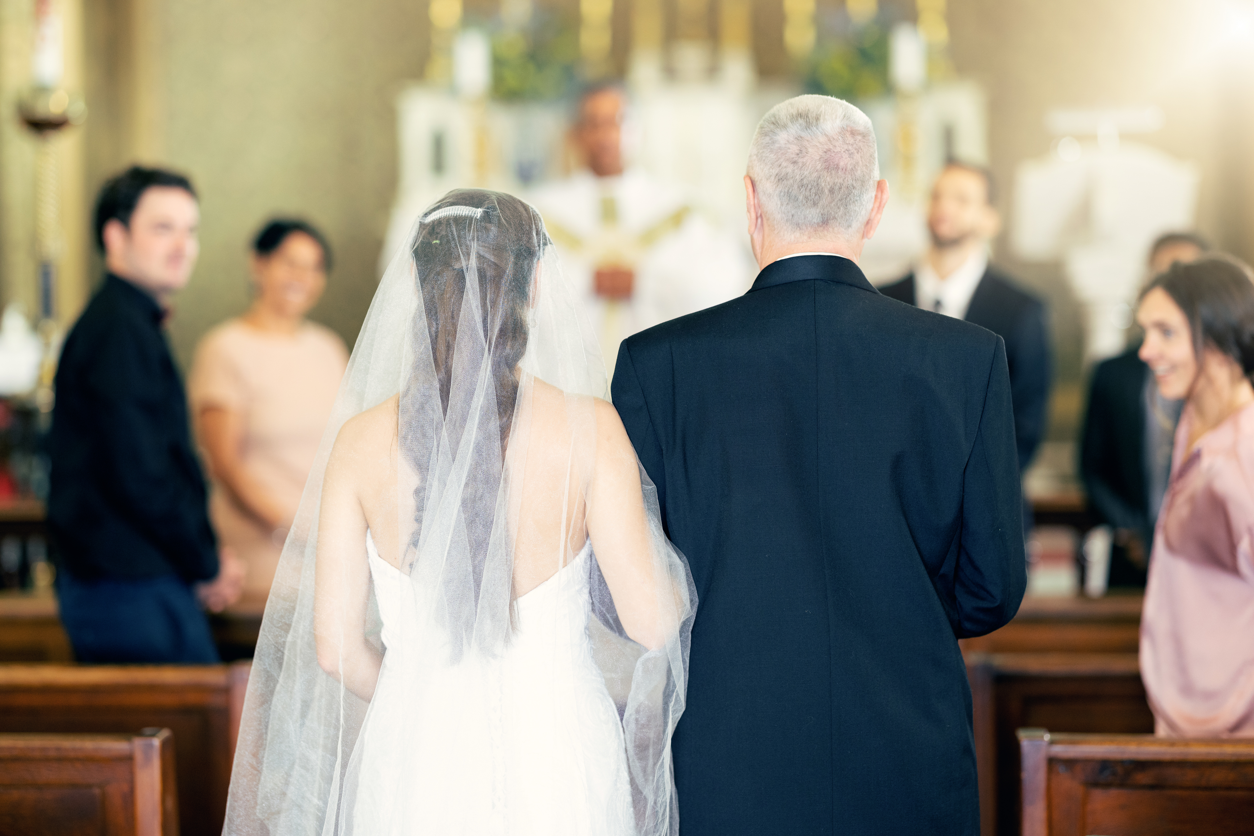 A bride and her father walking down the aisle