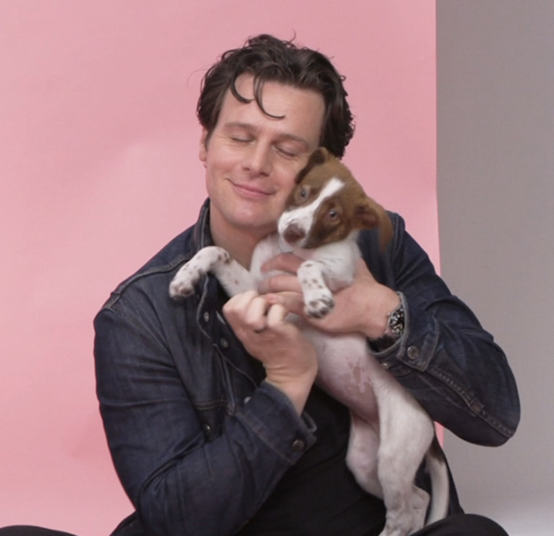 Closeup of Jonathan Groff with a puppy