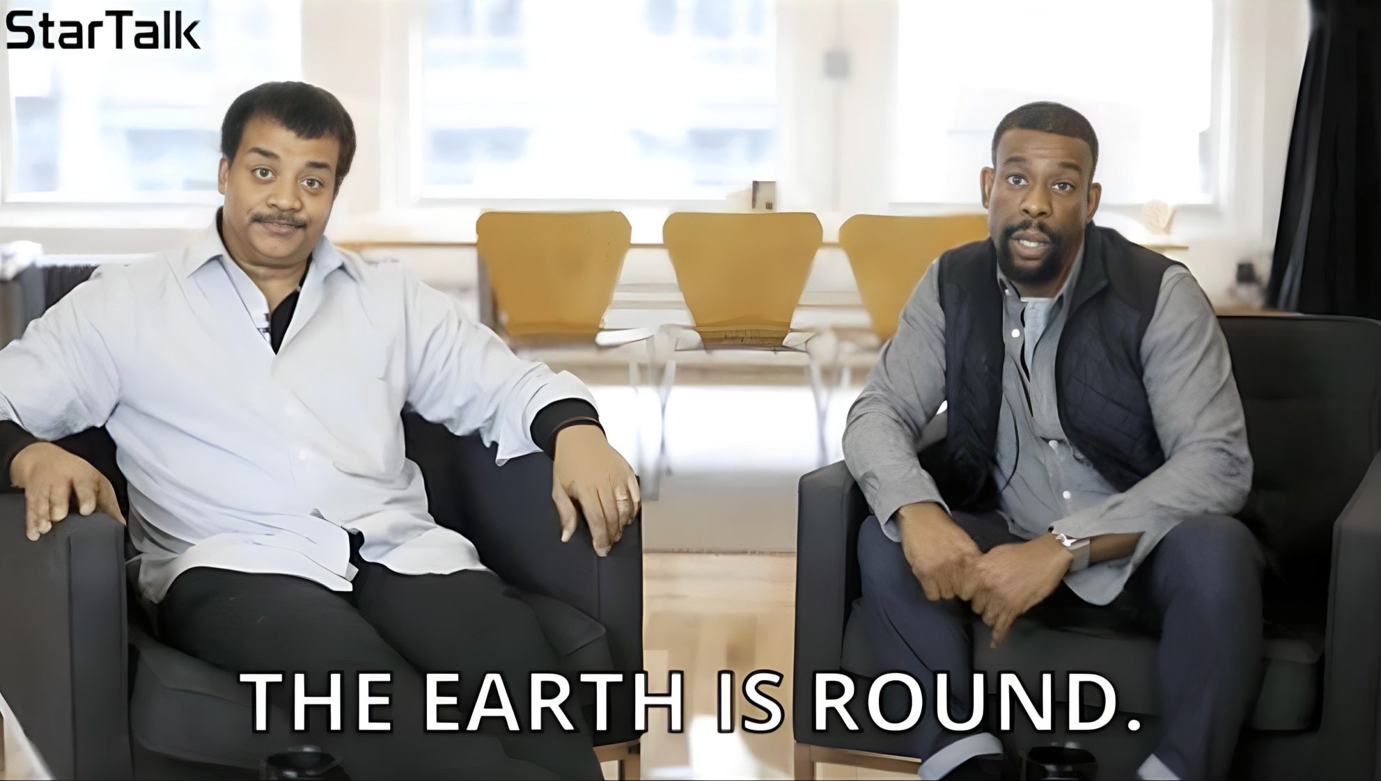 two people sitting chairs with text, the earth is round