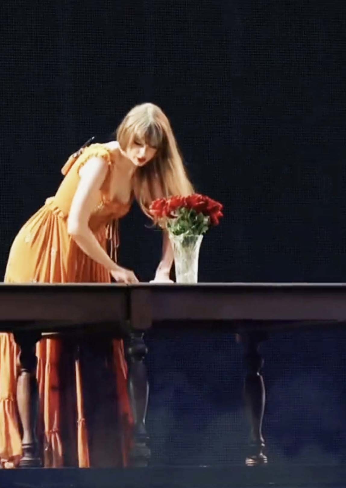 Taylor setting a table onstage