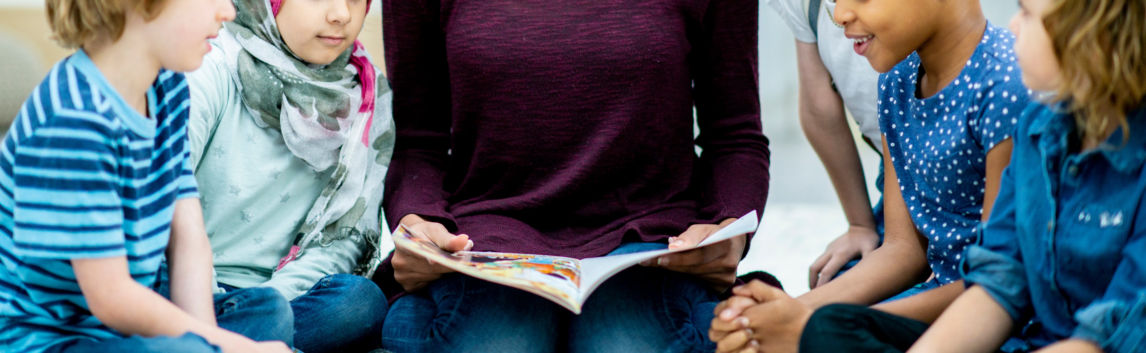 Someone reading a book to kids
