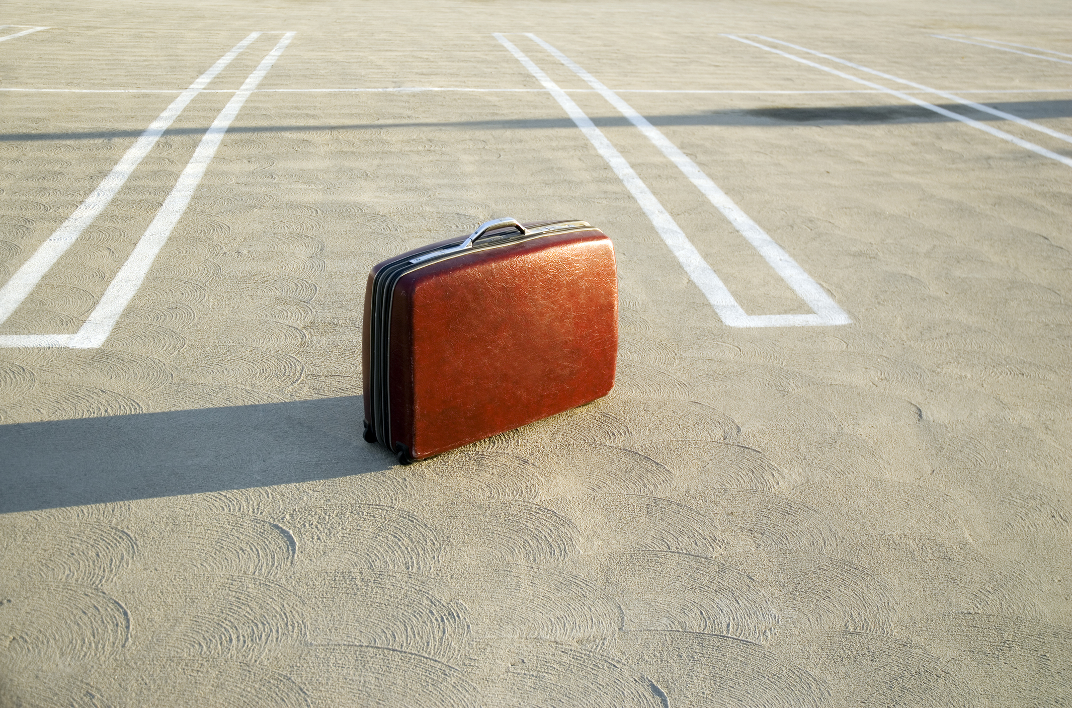 suitcase left in a parking lot