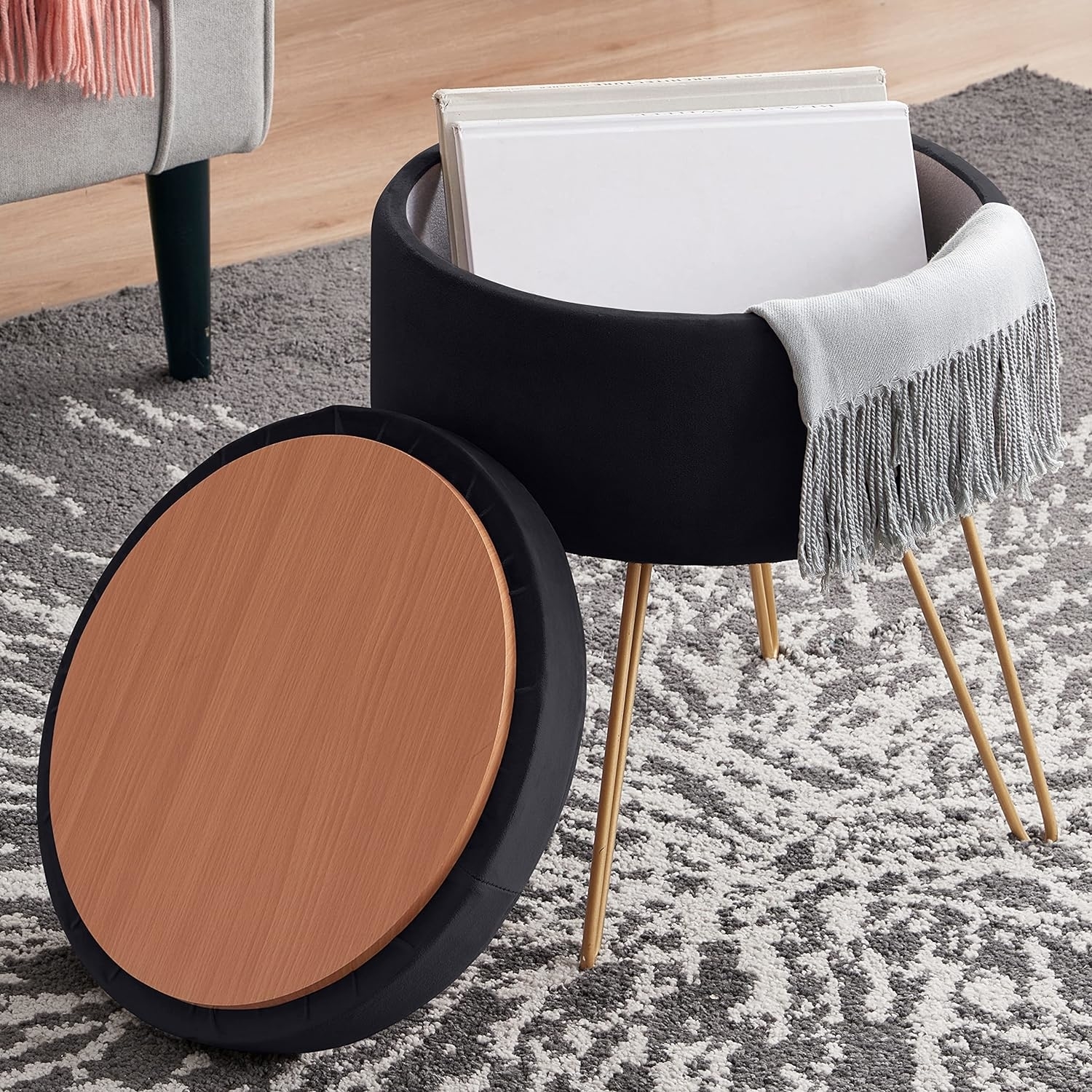 A gold hairpin legged black velvet ottoman with a removable lid