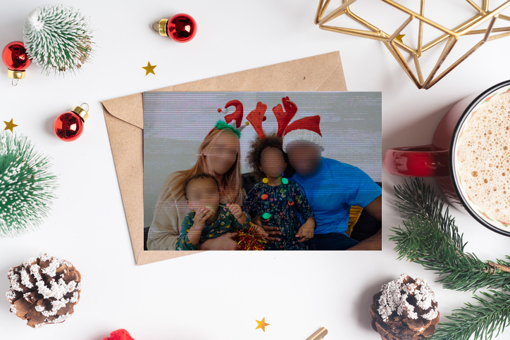 A Christmas card where the family&#x27;s faces are blurred