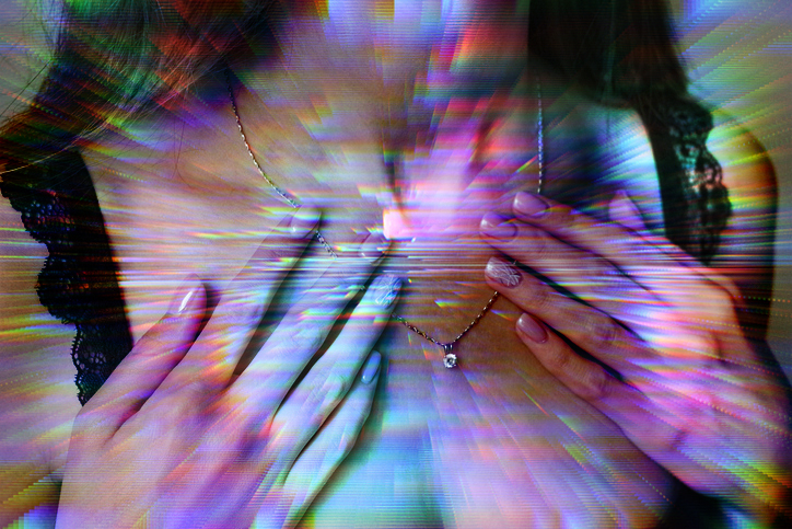 Distorted image of a woman touching her necklace