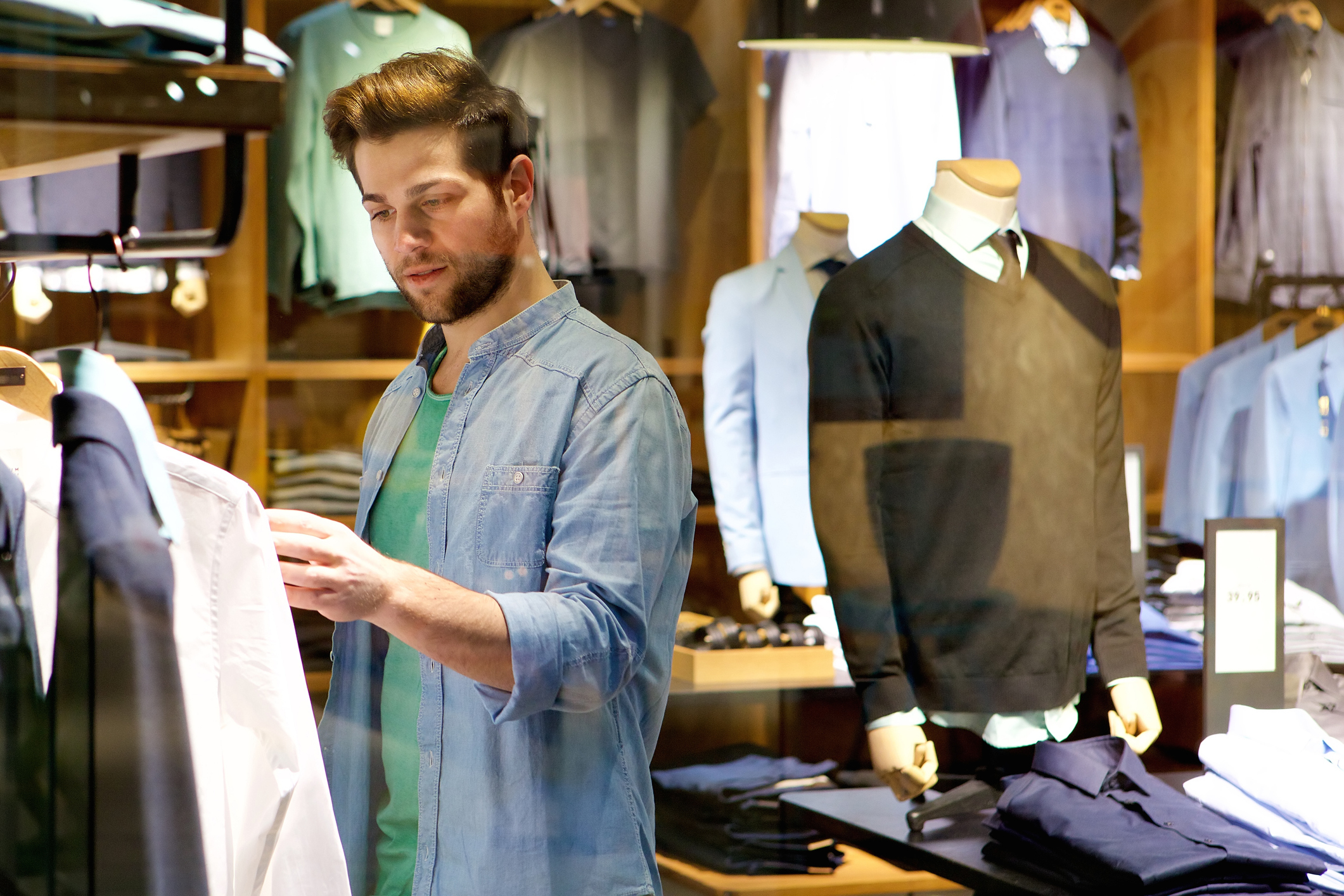 A man looking at clothes in a store