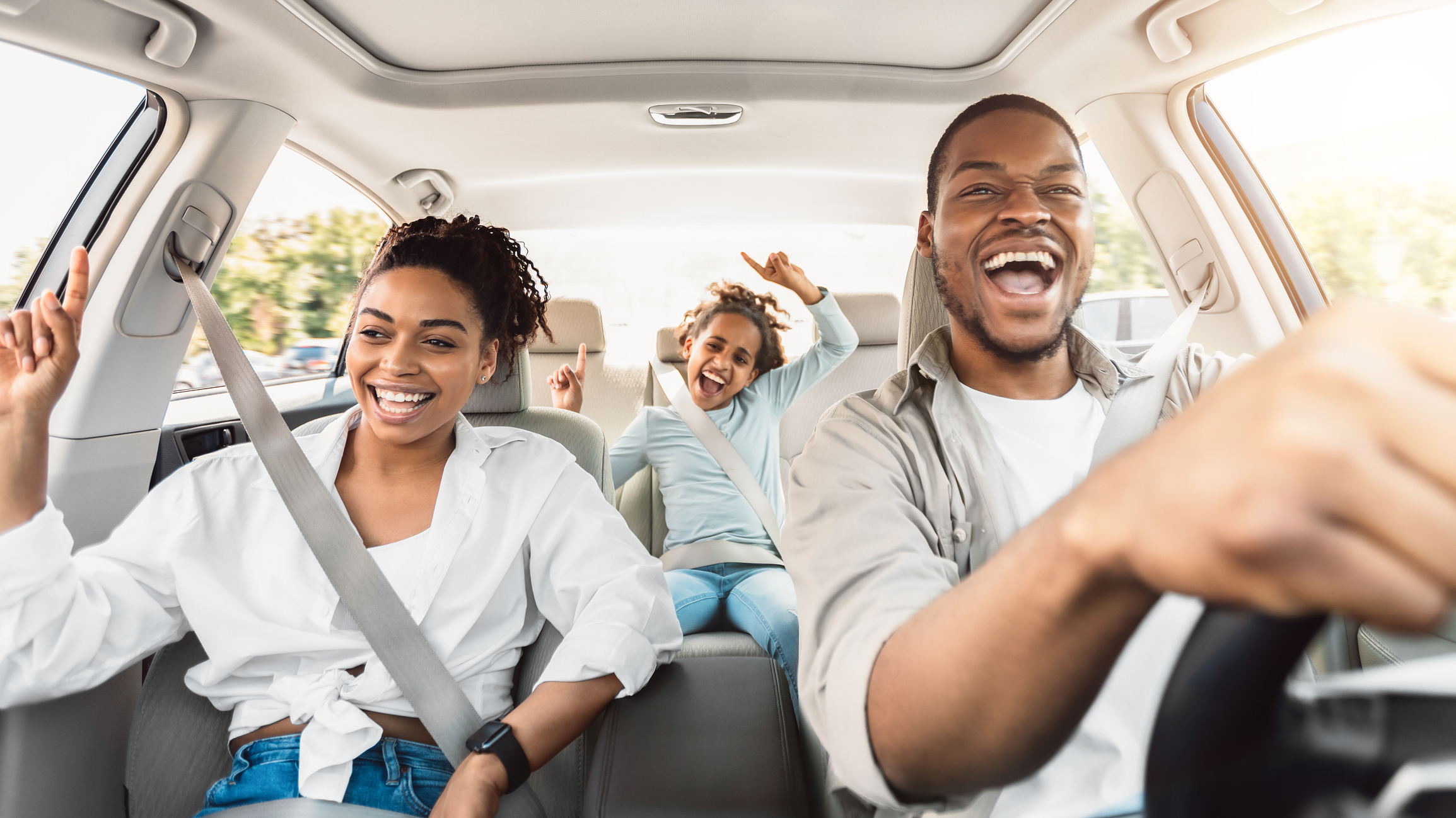 A family smiling in the car