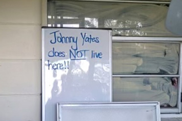 a whiteboard sign outside a home