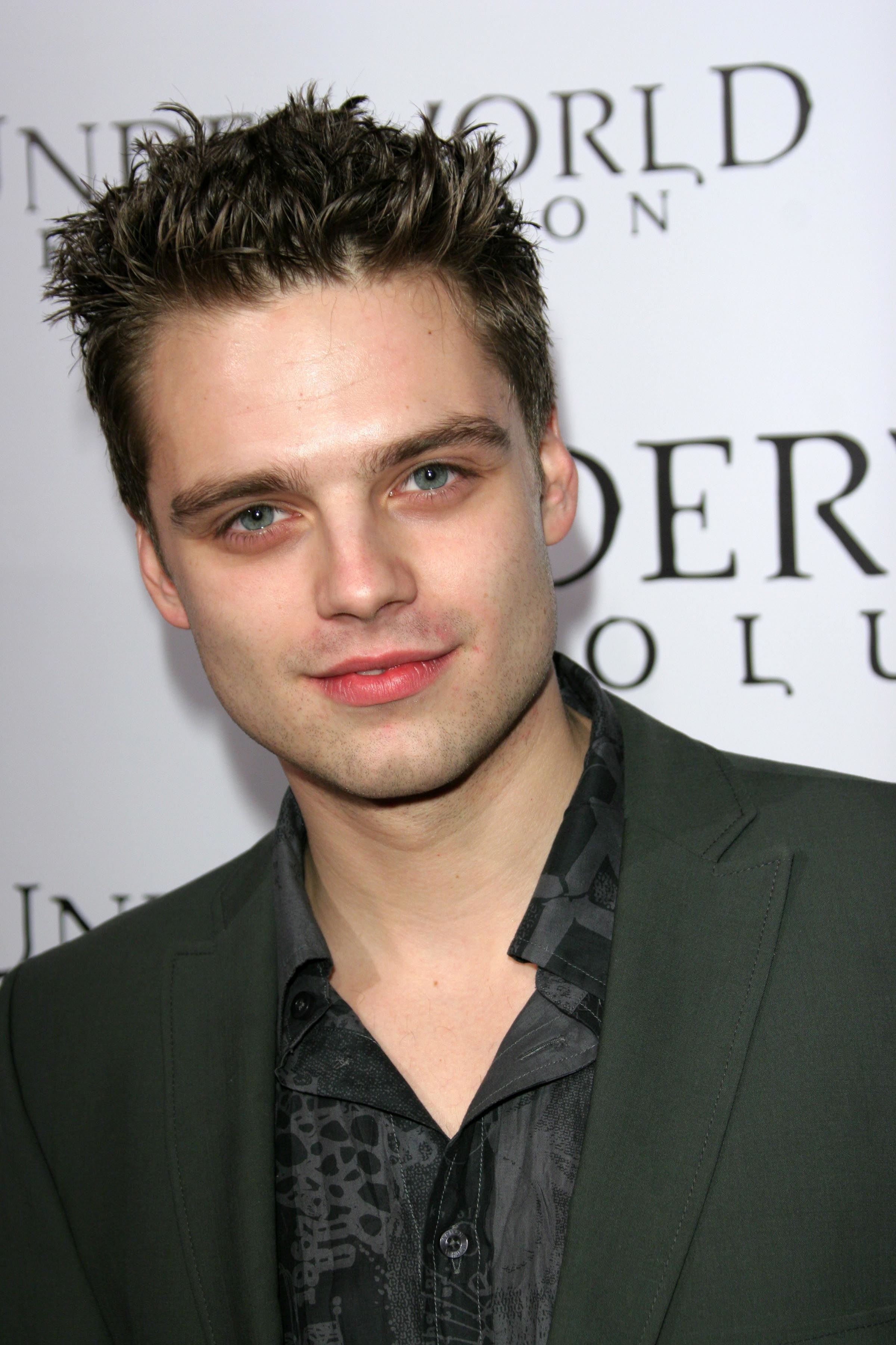 closeup of him in a suit with spiky hair