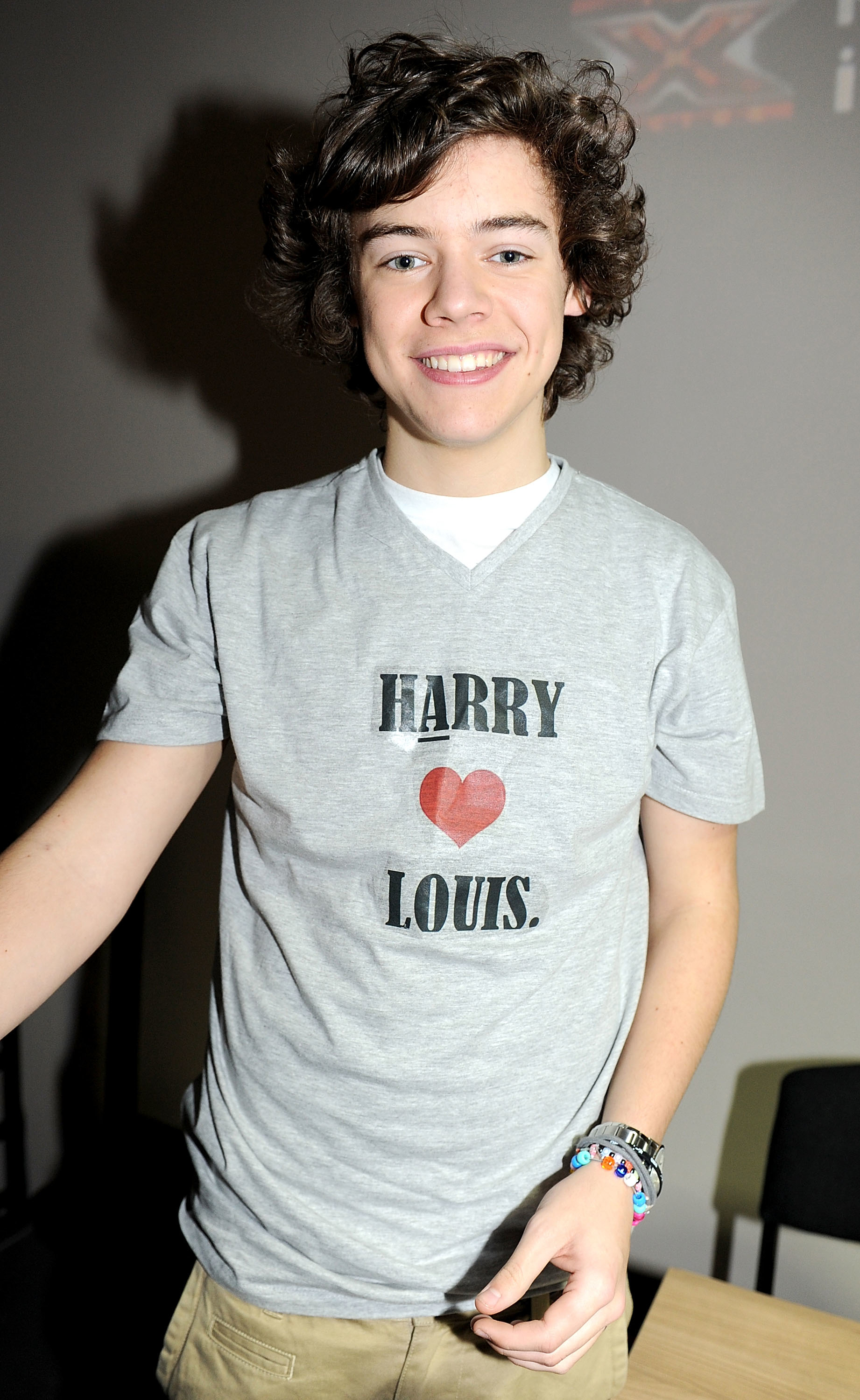 young harry wearing a t-shirt that reads harry heart louis
